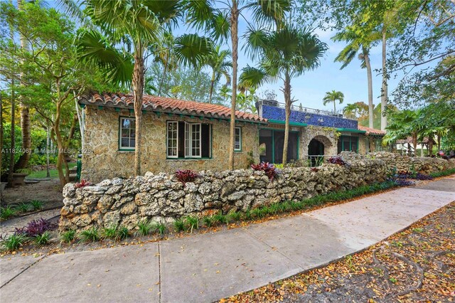 1301 Milan Ave Unit 5, Coral Gables, FL 33134 - single story home featuring a tile roof and stone siding