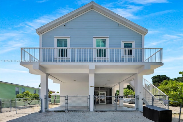 103 Long Key Rd, Key Largo, FL 33037 - rear view of property featuring a gate, a carport, and stairway