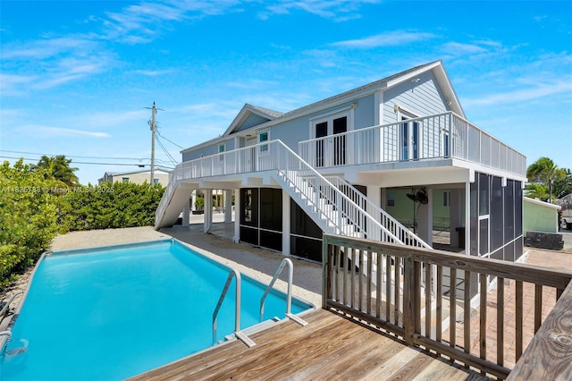 103 Long Key Rd, Key Largo, FL 33037 - rear view of house featuring a sunroom, stairway, a deck, and a patio
