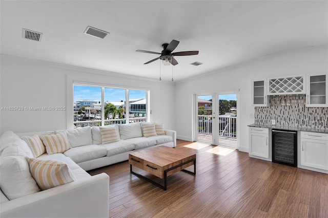 103 Long Key Rd, Key Largo, FL 33037 - living room featuring beverage cooler, bar area, dark wood-type flooring, ceiling fan, and ornamental molding