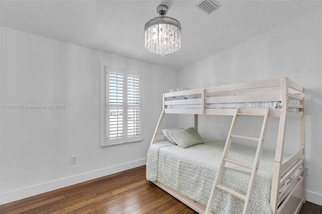 103 Long Key Rd, Key Largo, FL 33037 - bedroom with a chandelier and wood finished floors