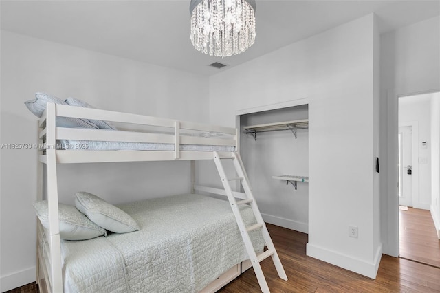 103 Long Key Rd, Key Largo, FL 33037 - bedroom featuring wood finished floors and a chandelier