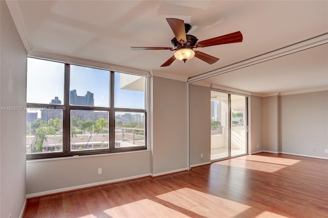 2500 Parkview Dr Unit 405, Hallandale Beach, FL 33009 - spare room with ornamental molding, plenty of natural light, wood finished floors, a view of city, and a ceiling fan