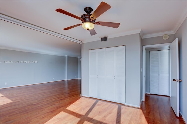 2500 Parkview Dr Unit 405, Hallandale Beach, FL 33009 - unfurnished bedroom with ornamental molding, wood finished floors, a closet, and ceiling fan