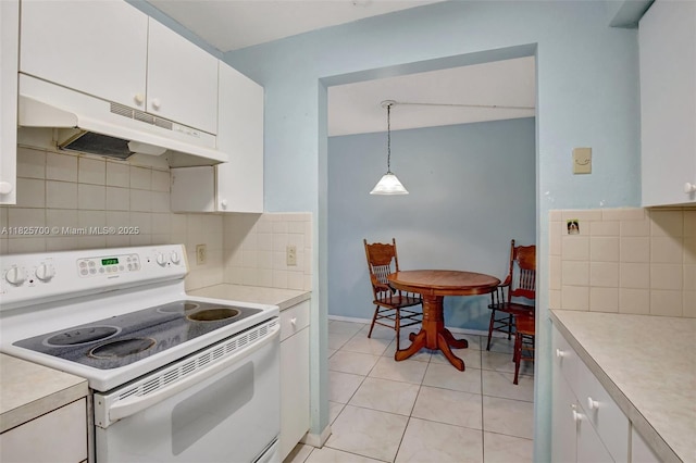 13155 SW 7th Ct Unit 308E, Pembroke Pines, FL 33027 - kitchen featuring electric stove, under cabinet range hood, light countertops, white cabinets, and light tile patterned floors