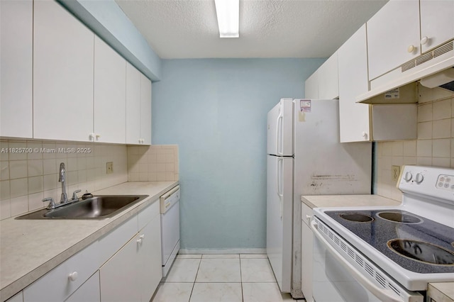 13155 SW 7th Ct Unit 308E, Pembroke Pines, FL 33027 - kitchen with white appliances, under cabinet range hood, backsplash, light countertops, and white cabinets