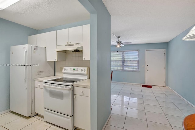 13155 SW 7th Ct Unit 308E, Pembroke Pines, FL 33027 - kitchen with white appliances, under cabinet range hood, a textured ceiling, light countertops, and white cabinets