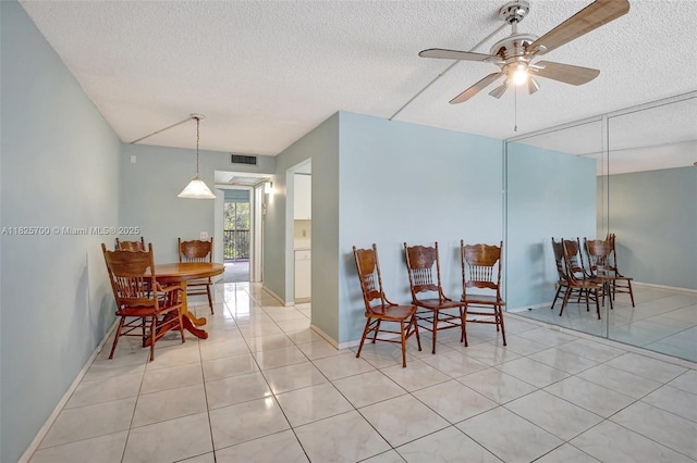 13155 SW 7th Ct Unit 308E, Pembroke Pines, FL 33027 - tiled dining area with a textured ceiling and ceiling fan