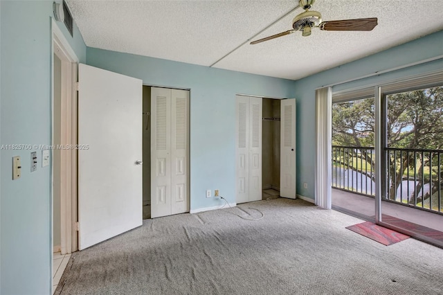 13155 SW 7th Ct Unit 308E, Pembroke Pines, FL 33027 - unfurnished bedroom featuring access to exterior, carpet flooring, a textured ceiling, two closets, and ceiling fan