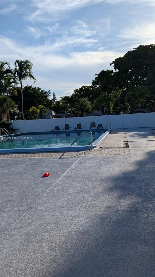 1001 Hillcrest Ct Unit 303, Hollywood, FL 33021 - view of tennis court featuring a community pool