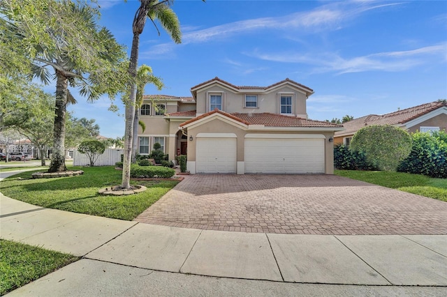 1379 NW 166th Ave, Pembroke Pines, FL 33028 - view of front of house featuring stucco siding, decorative driveway, a front yard, a tiled roof, and an attached garage