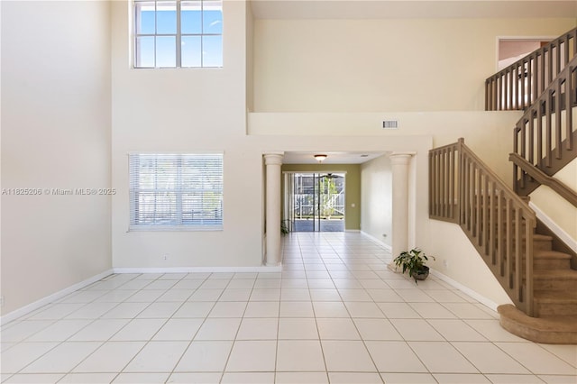 1379 NW 166th Ave, Pembroke Pines, FL 33028 - tiled foyer featuring stairs, a high ceiling, and decorative columns