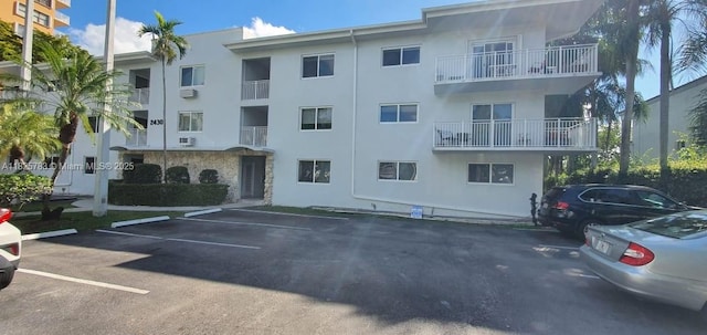 2430 NE 135th St Unit 304, North Miami, FL 33181 - view of apartment building / complex with uncovered parking