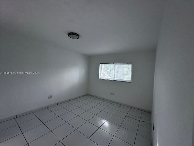 2430 NE 135th St Unit 304, North Miami, FL 33181 - spare room featuring light tile patterned floors