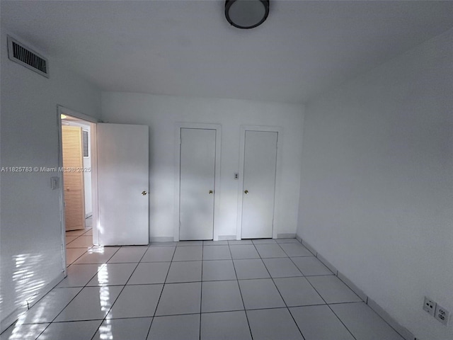 2430 NE 135th St Unit 304, North Miami, FL 33181 - unfurnished bedroom with light tile patterned floors