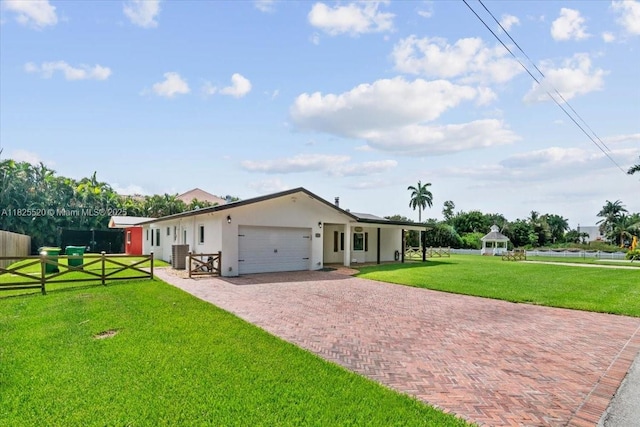 1550 NW 114th Ave, Plantation, FL 33323 - view of front of home featuring a garage, decorative driveway, stucco siding, and a gazebo