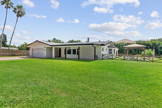 1550 NW 114th Ave, Plantation, FL 33323 - ranch-style home with a gazebo, an attached garage, concrete driveway, and stucco siding
