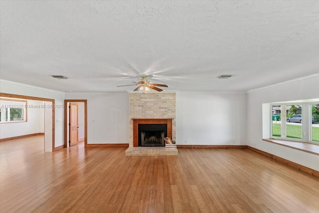 1550 NW 114th Ave, Plantation, FL 33323 - unfurnished living room featuring ceiling fan, light wood finished floors, a textured ceiling, a fireplace, and ornamental molding