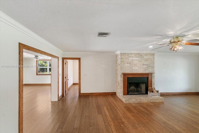 1550 NW 114th Ave, Plantation, FL 33323 - unfurnished living room with ceiling fan, wood finished floors, a fireplace, ornamental molding, and a textured ceiling