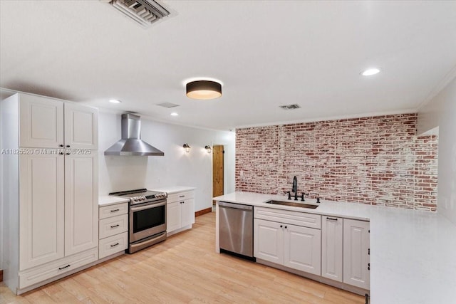 1550 NW 114th Ave, Plantation, FL 33323 - kitchen with appliances with stainless steel finishes, wall chimney range hood, light countertops, light wood finished floors, and recessed lighting