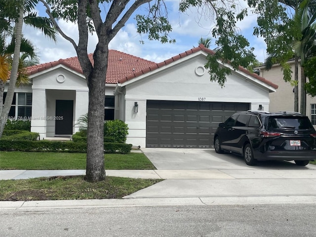 1087 Chenille Cir, Weston, FL 33327 - mediterranean / spanish house featuring an attached garage, stucco siding, a tile roof, and driveway