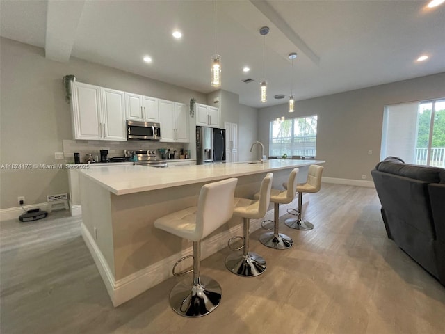 1087 Chenille Cir, Weston, FL 33327 - kitchen featuring stainless steel appliances, light wood-style flooring, plenty of natural light, and recessed lighting