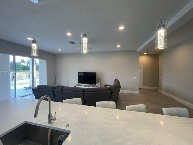 1087 Chenille Cir, Weston, FL 33327 - kitchen featuring wood finished floors, recessed lighting, decorative light fixtures, and ceiling fan