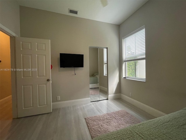 1087 Chenille Cir, Weston, FL 33327 - unfurnished bedroom with light wood finished floors and baseboards