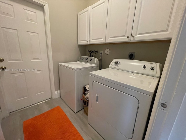 1087 Chenille Cir, Weston, FL 33327 - laundry room featuring cabinet space, light wood-style flooring, and separate washer and dryer