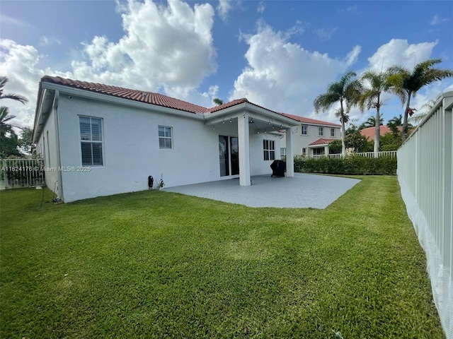 1087 Chenille Cir, Weston, FL 33327 - rear view of house with a tiled roof, a patio area, a fenced backyard, and stucco siding