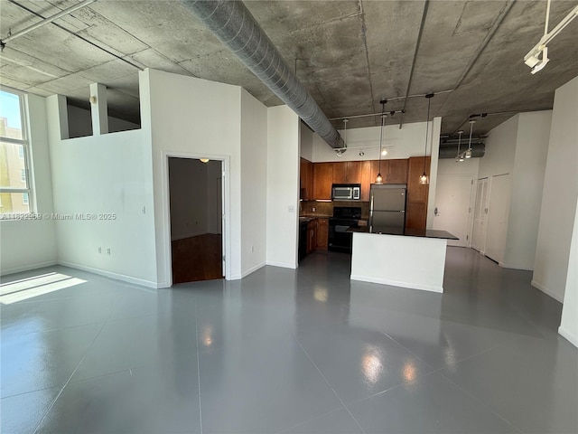 2001 Biscayne Blvd Unit 2402, Miami, FL 33137 - kitchen with appliances with stainless steel finishes, dark countertops, a towering ceiling, and brown cabinets