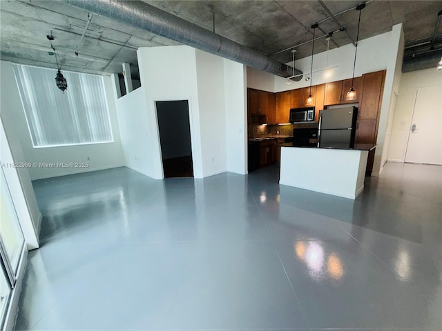 2001 Biscayne Blvd Unit 2402, Miami, FL 33137 - kitchen featuring freestanding refrigerator, stainless steel microwave, a towering ceiling, a kitchen island, and open floor plan
