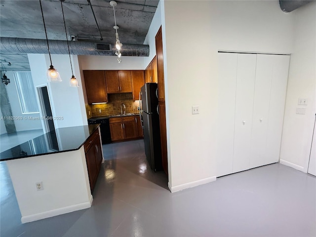 2001 Biscayne Blvd Unit 2402, Miami, FL 33137 - kitchen featuring backsplash, track lighting, dark countertops, finished concrete floors, and freestanding refrigerator