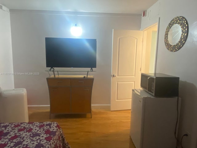 19001 NE 14th Ave Unit 325, Miami, FL 33179 - bedroom with light wood-style floors and baseboards