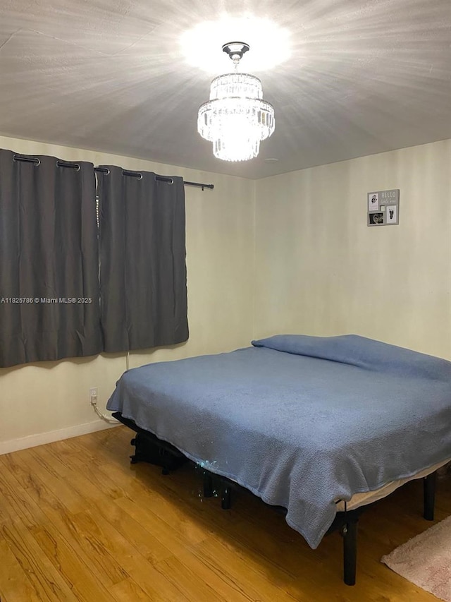 19001 NE 14th Ave Unit 325, Miami, FL 33179 - bedroom with a chandelier and wood finished floors