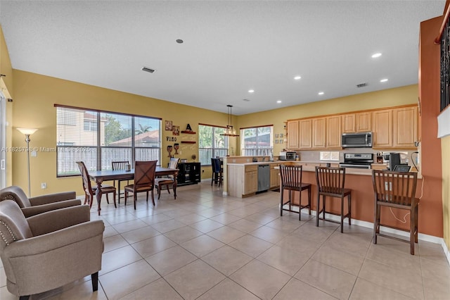 452 NE 20th Ter, Homestead, FL 33033 - kitchen with appliances with stainless steel finishes, a peninsula, light brown cabinets, open floor plan, and recessed lighting