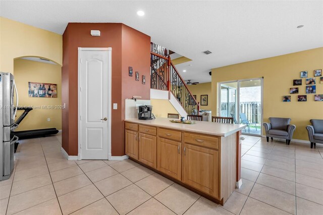 452 NE 20th Ter, Homestead, FL 33033 - kitchen with light tile patterned floors, a peninsula, light countertops, freestanding refrigerator, and recessed lighting
