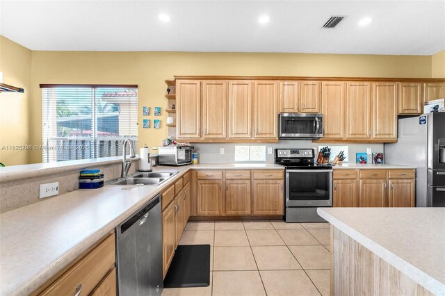 452 NE 20th Ter, Homestead, FL 33033 - kitchen featuring appliances with stainless steel finishes, light brown cabinetry, light countertops, healthy amount of natural light, and recessed lighting