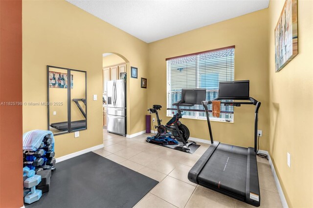 452 NE 20th Ter, Homestead, FL 33033 - exercise room featuring arched walkways and light tile patterned floors