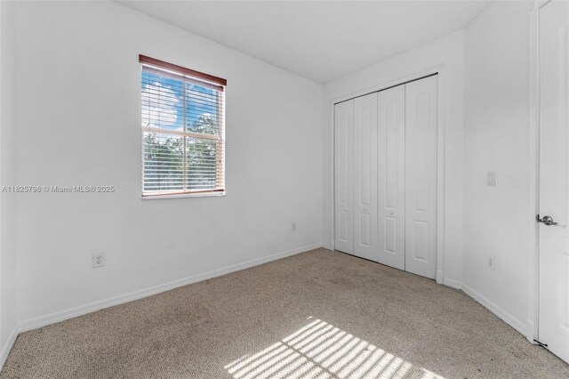452 NE 20th Ter, Homestead, FL 33033 - unfurnished bedroom featuring carpet flooring and a closet