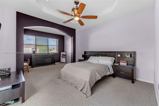 452 NE 20th Ter, Homestead, FL 33033 - bedroom with light carpet, arched walkways, and a raised ceiling
