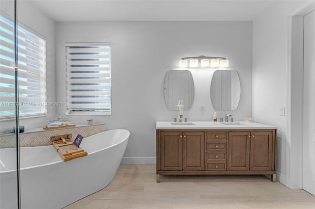 452 NE 20th Ter, Homestead, FL 33033 - full bathroom with plenty of natural light, a soaking tub, double vanity, and tile patterned floors