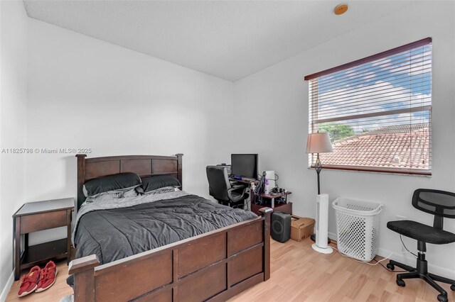 452 NE 20th Ter, Homestead, FL 33033 - bedroom featuring light wood finished floors and baseboards