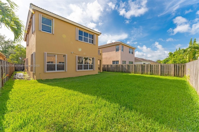 452 NE 20th Ter, Homestead, FL 33033 - rear view of house with stucco siding and a fenced backyard