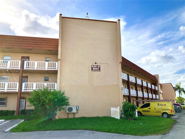 9041 Sunrise Lakes Blvd Unit 208, Sunrise, FL 33322 - view of apartment building / complex featuring uncovered parking