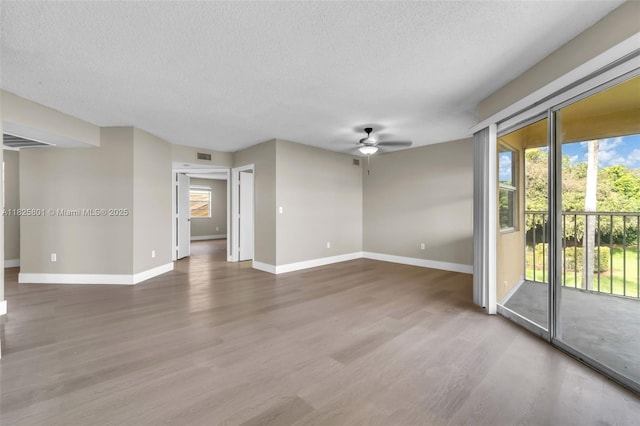 2246 SE 27th Dr Unit 204-D, Homestead, FL 33035 - unfurnished living room with a textured ceiling, wood finished floors, and a ceiling fan