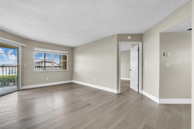 2246 SE 27th Dr Unit 204-D, Homestead, FL 33035 - empty room with a textured ceiling and wood finished floors