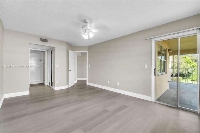 2246 SE 27th Dr Unit 204-D, Homestead, FL 33035 - empty room featuring wood finished floors, a ceiling fan, and a textured ceiling
