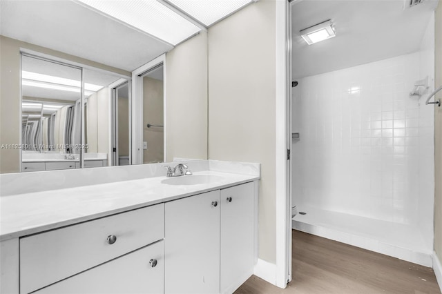 2246 SE 27th Dr Unit 204-D, Homestead, FL 33035 - full bathroom featuring wood finished floors, vanity, and a tile shower