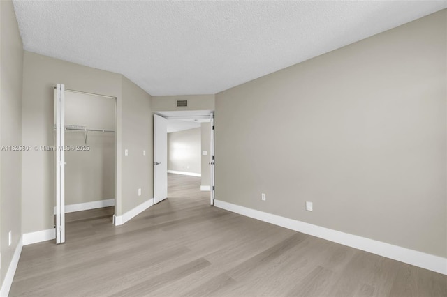2246 SE 27th Dr Unit 204-D, Homestead, FL 33035 - unfurnished bedroom featuring wood finished floors, a closet, and a textured ceiling